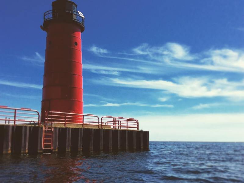a large clock tower sitting next to a body of water