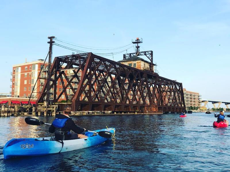 a blue and white boat parked next to a body of water