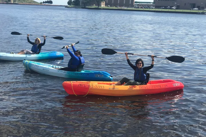 a group of people on a boat in a body of water